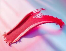 red lipstick texture on a gradient pink and blue background. Pink Lipstick Swirl photo
