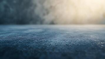 Texture of a concrete surface in a studio with a soft, hazy background that is moody and calming. Ideal as a backdrop photo