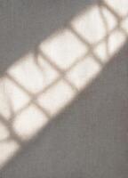 Sunlight through the blinds on a linen background. Copy space. Light and Shadow Grid photo