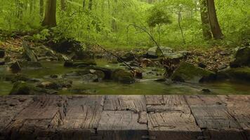Empty wooden table with green trees in forest bokeh blurred space with flowing river copy background for display of food and health products video