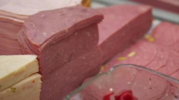 Different varieties of deli meats displayed in a market video