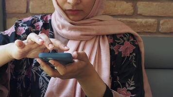 Engaging with a smartphone in a cozy cafe setting video