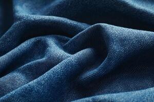 Closeup of Wrinkled Blue Denim Fabric Texture with Light and Shadow Patterns for Textile Backgrounds photo