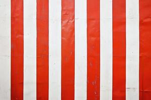 Red and White Vertical Striped Pattern on a Textured Wall with Subtle Wear Marks photo