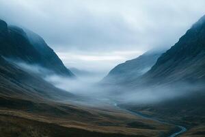 Misty Mountain Valley With Rolling Fog and Serene River Under Overcast Sky in Winter Landscape photo