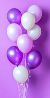Cluster of Purple and White Balloons Against Bright Violet Background for Celebrations and Parties photo