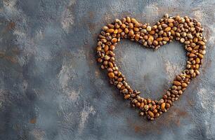 Heart Shape Made of Mixed Nuts on Textured Gray Concrete Background for Health and Food Concept photo