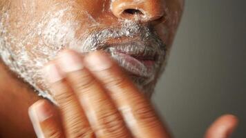 Man applying shaving cream for a smooth shave at home video