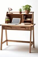 A desk with a laptop and a plant on it photo
