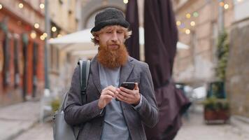 Man use smartphone looking for a way route on map in mobile navigator app, finishing, going away video