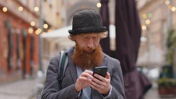 Man use smartphone looking for a way route on map in mobile navigator app, finishing, going away video