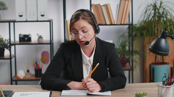 Businesswoman working on laptop wearing headset call center support service operator office helpline video