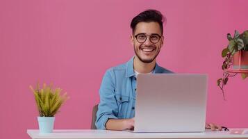 Happy Young Content Creator Exuding Success while Working on a Colorful Background photo