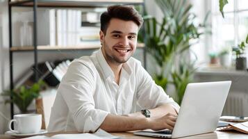 Cheerful young business professional working intently on laptop in modern office environment photo