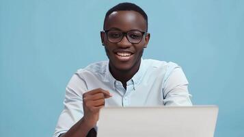 Confident Young Brand Manager Smiling and Working on Laptop in Modern Office Setting photo