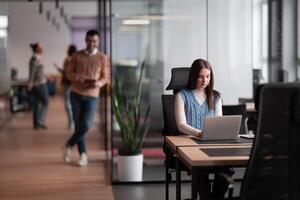 Senior bearded businessman, IT professional, trader, and crypto investor using a digital tablet in a modern coworking space. Tech-savvy professional working in an open office startup environment photo