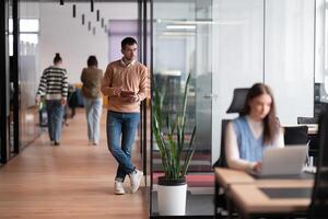 Senior bearded businessman, IT professional, trader, and crypto investor using a digital tablet in a modern coworking space. Tech-savvy professional working in an open office startup environment photo