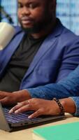 Young couple at desk reading research papers and multitasking with laptop at home office, diving into professional or personal topics of improvement. Self employed people review analysis. Camera A. video