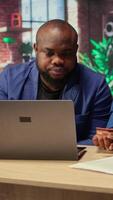 Young people using a card to check the financial balance before buying or paying something, e commerce from the home office. African american couple doing web transactions. Camera A. video