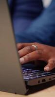 Young couple at desk reading research papers and multitasking with laptop at home office, diving into professional or personal topics of improvement. Self employed people review analysis. Camera B. video