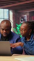 Tech savvy people working on a wireless laptop to test a new software, navigating new digital tools and managing virtual tasks. Connected and productive lifestyle at home. Camera A. video