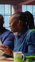 African American angry woman pulling out the LAN cable from the router while her partner reads a technical manual for troubleshooting. Couple getting mad and arguing over signal loss. Camera A. video