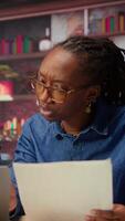 Black people both working from home at their designated office, using online tools on computer for tasks management. Completing operations efficiently from their comfortable house. Camera A. video