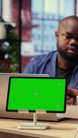 African American couple browse troubleshooting guide next to chroma key, working together to debug router issues and restore their home network. Freelancers getting angry. Camera B. video