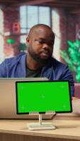 African American couple browse troubleshooting guide next to chroma key, working together to debug router issues and restore their home network. Freelancers getting angry. Camera A. video