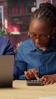 African American couple discusses mortgage and insurance payments at home, using calculator to do their household budgeting and money management. Ensuring a secure financial future. Camera A. video