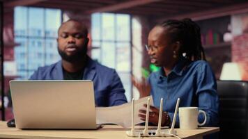 Discouraged African American couple struggles with an unstable Wi Fi network, getting angry while they are troubleshooting to fix the error. Stressed people with lots of remote tasks. Camera B. video