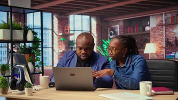 Tech savvy people working on a wireless laptop to test a new software, navigating new digital tools and managing virtual tasks. Connected and productive lifestyle at home. Camera A. video