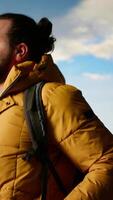 Vertical Trekker in warm clothing gazes at the panoramic mountain range, embracing the sense of adventure and the personal growth that comes with exploring most breathtaking landscapes. Camera B. video