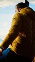Vertical Determined trekker looks out at the epic mountain range and sightseeing, inspired by the vastness of the sky and the rugged peaks. Reward of embracing the great outdoors. Camera B. video