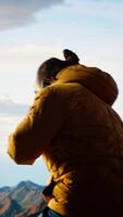 Vertical Careless hiker tries to make a phone call on the mountain top and falling off a cliff, causing the accident due to his obsession with technology and always staying connected. Camera B. video