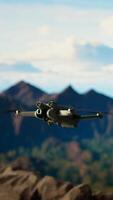 Vertical Mountain range explorer filming a professional and trekking through scenic peaks, sharing his journey with a global audience. Modern hiker recording a vlog on his drone. Camera A. video