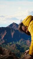 Vertical Hiker battling strong winds and cold weather tumbles over a cliff on the mountain top, dangerous risky place for trekking. Unprepared adventure seeker being foolish and tripping. Camera A. video
