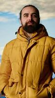 Vertical Hiker gazes at the panoramic view of dramatic mountain peaks and clouds, feeling the thrill of adventure and rewards of perseverance. The journey represents strength and personal growth. Camera B. video
