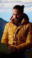 Vertical Modern online entrepreneur with technology reliance on a mountain top, always connected workaholic hiker admires the scenic landscape. Remote access high connectivity. Camera B. video