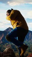 Vertical Careless hiker tries to make a phone call on the mountain top and falling off a cliff, causing the accident due to his obsession with technology and always staying connected. Camera A. video
