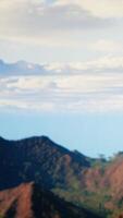 Vertical Foolish hiker acting careless dropping smartphone and losing balance, person unequipped for the harsh mountain environment. Risks of trekking with a technology obsession in nature. Camera B. video