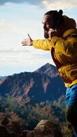 Vertical Clumsy foolish hiker dropping his phone in search of signal on mountain top, his lack of attention causes an accident in the nature. Reckless person unprepared tumbling. Camera A. video