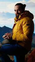 Vertical Content creator enjoying the fresh air and filming with his drone, recording professional on mountain range valley aerial view. Influencer filming his latest travel vlog. Camera A. video