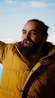 Vertical Adventure seeker stands on top a high altitude mountain for a breathtaking view, pleased hiker raising his arms and screaming in satisfaction. Conquering fears and challenges. Camera B. video