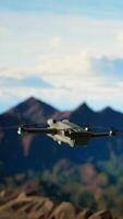 Vertical Traveler balances adventure and creating content by filming with his drone, recording the aerial view of a beautiful mountain range. Breathtaking landscape scenery videography. Camera A. video
