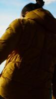 Vertical Determined climber pauses to admire the scenic view with mountains and a vast sky create a breathtaking backdrop. Man hiking for exploration and adventure in the nature. Camera B. video