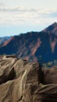 Vertical Dramatic alpine landscape featuring rugged rock formations and lush forested slopes. This epic view invites trekkers and explorers to embrace nature and conquer new heights on their journey. video