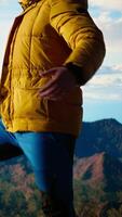 Vertical Peaceful pleased traveler feeling happy climbing the mountain, enjoying mindfulness and determination. Young man being passionate about the wilderness and the scenic view. Camera A. video
