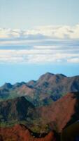 Vertical Hiker takes a moment to admire the panoramic view of mountains, looking into the distance and sightseeing. Fresh air, scenic background and peaceful surroundings for an explorer. Camera B. video