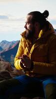 Vertical Explorer embraces the thrill of reaching a mountain summit and relaxing, feeling the fresh air and panoramic beauty. Hiker being excited and tired, proud of self improvement and goals. Camera A. video
